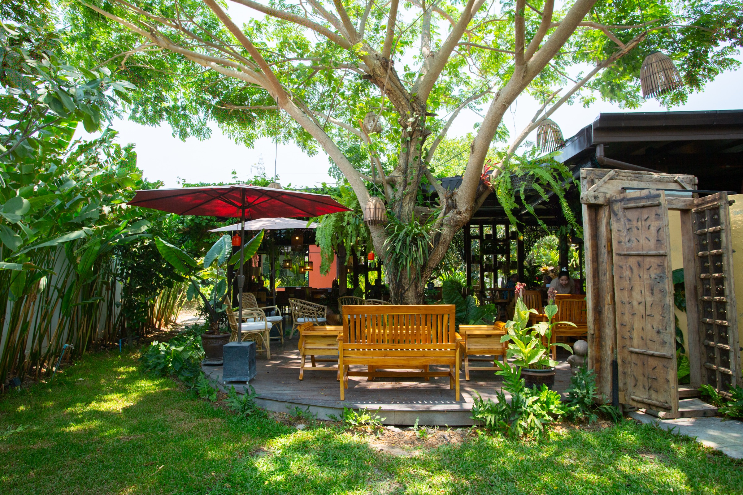 Welcoming shaded garden and seating at Apsara