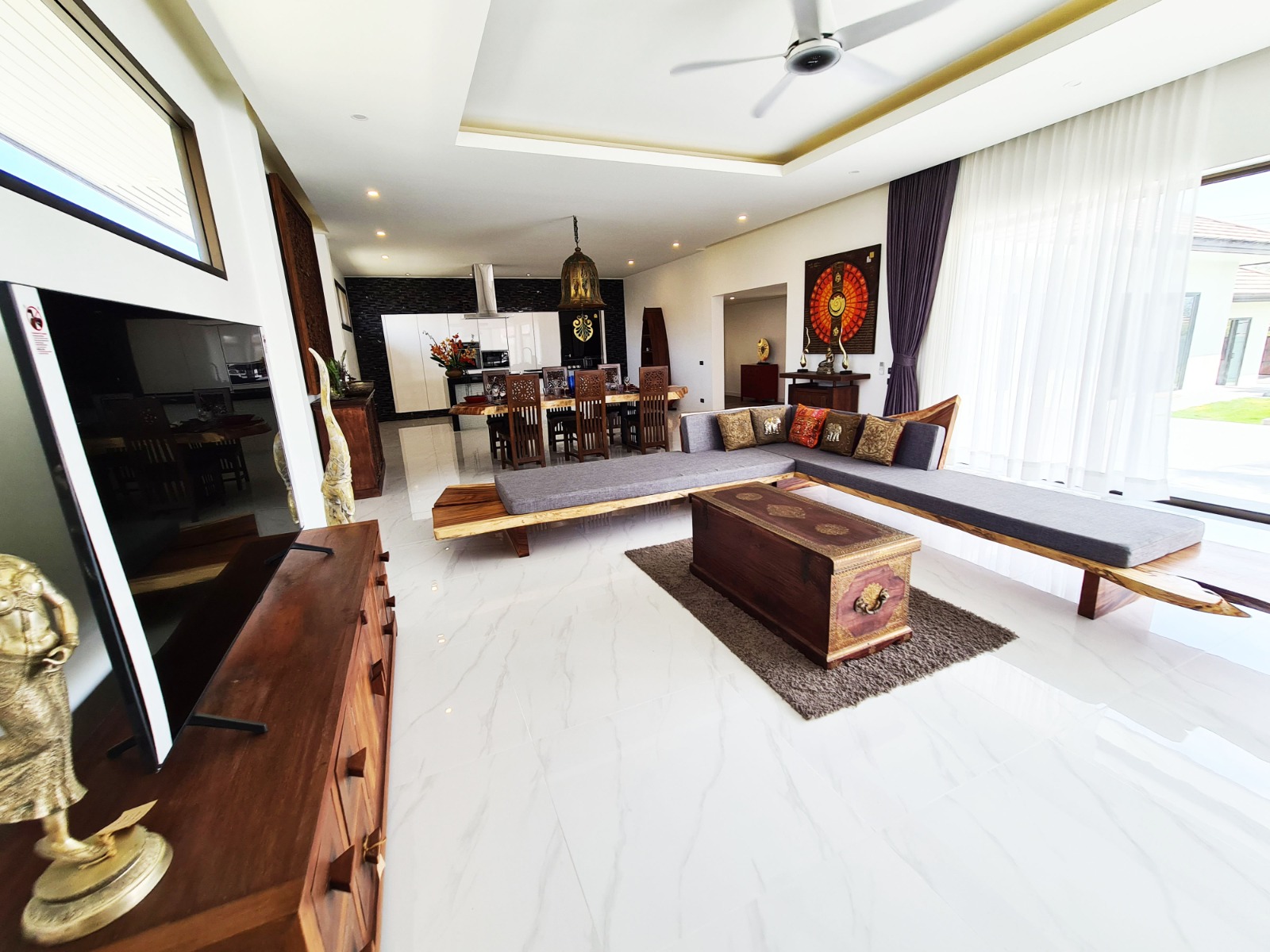 Bright living room with carved decor and garden-facing windows